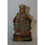 A Polychrome figure of a Chinese emperor sitting o