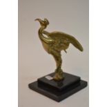 A brass car mascot formed as an exotic bird mounte
