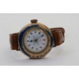 A lady's left handed, gold cased, enamel dial wri