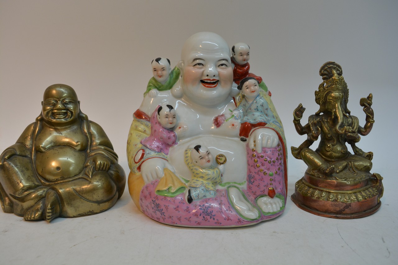 A Chinese porcelain Buddha, a brass Buddha and a s