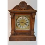 A small bracket clock with silvered dial