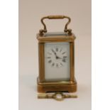 A miniature brass key wind carriage clock