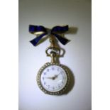 An 18ct gold blue enamel fob watch on a blue ename