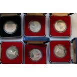 Six cased silver coins comprising mainly Crowns (6