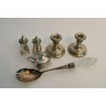 A pair of silver candlesticks, silver cruet set an