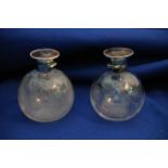 A pair of Edwardian glass perfume bottles with tor