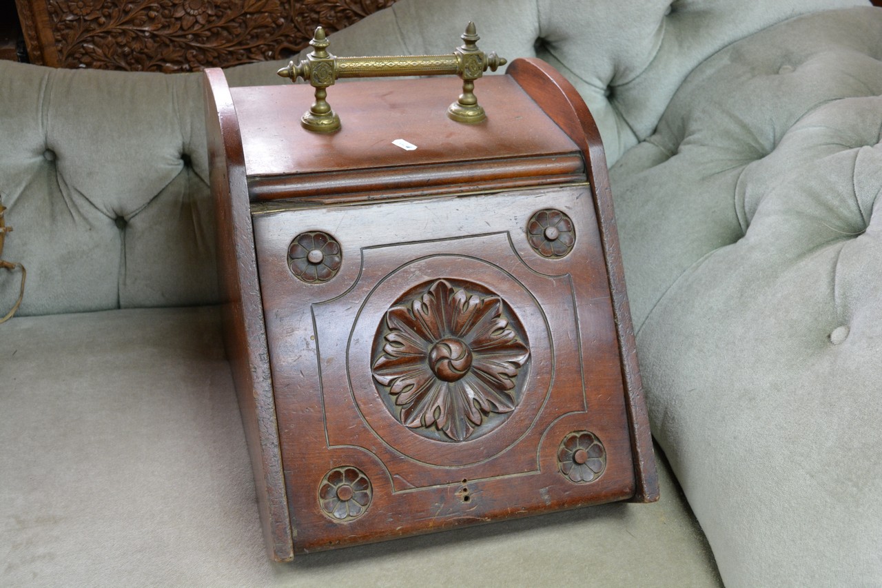 A carved walnut coal box