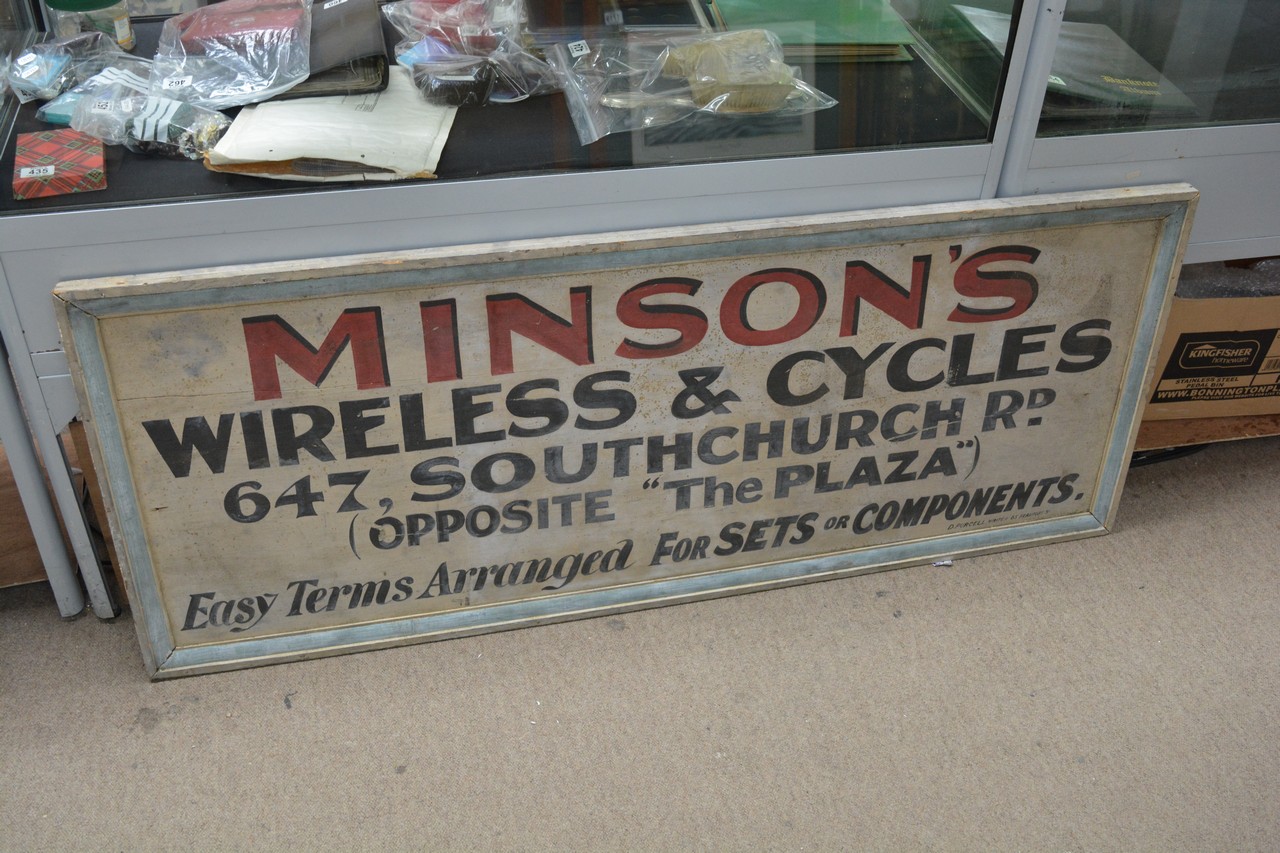 A wooden shop sign for "Minson's wireless & cycles" 155cm x 62cm