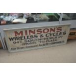 A wooden shop sign for "Minson's wireless & cycles" 155cm x 62cm