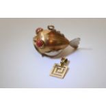 An 18ct gold pendant in the form of a fish with coral eyes and a 14ct gold pendant (2).