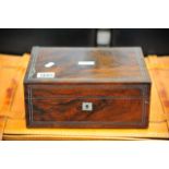 A 19th century rosewood traveling box with a well