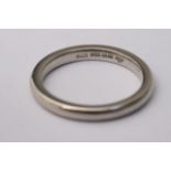 A platinum wedding band, approximately size Q