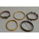 Three silver bangles and two Gold plated bangles