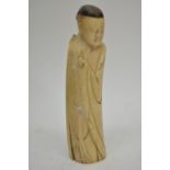 A Chinese carved antique ivory figure of robed man