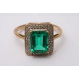 A boxed 9ct gold ring set with square cut green st