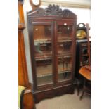 An Edwardian display cabinet with a pair of glazed