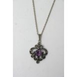 A vintage silver necklace with attached amethyst p