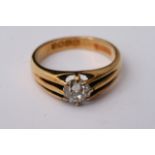 An 18ct yellow gold ring set with a single diamond