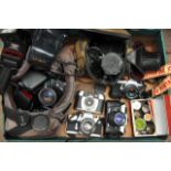 A box of various cameras and accessories including
