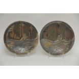 A pair of Dutch earthenware wall plates having inc