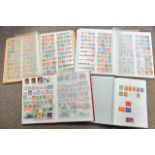 Blue stamp album and three full red stockbooks