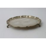 A silver scalloped card tray on scrolled feet, Bir