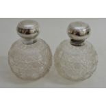 A pair of silver and cut glass scent bottles of sp