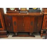 An oak sideboard fitted with three cupboard doors