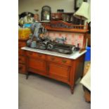 An Edwardian marble topped wash stand with tile ba