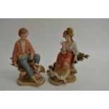 A pair of Capodimonte figures comprising a boy and