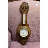 An Oak carved Barometer with applied thermometer b