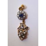 A diamond, pearl and sapphire pendant.