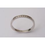 An 18ct gold half hoop eternity ring set with diam