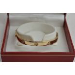 A gold bangle set with ten diamonds