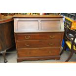 A mahogany bureau, the fall front above three draw