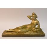 An Art Deco style plaster figure of a reclining gi