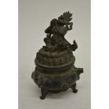 An Indian bronze pot wiith a lid depicting an Indi