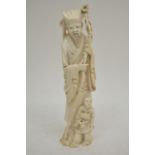 A Chinese carved antique ivory figure of an elder