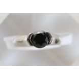 A Platinum Ring set with single black diamond plus