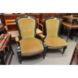 A pair of lady and gent's chairs with ebonised fra