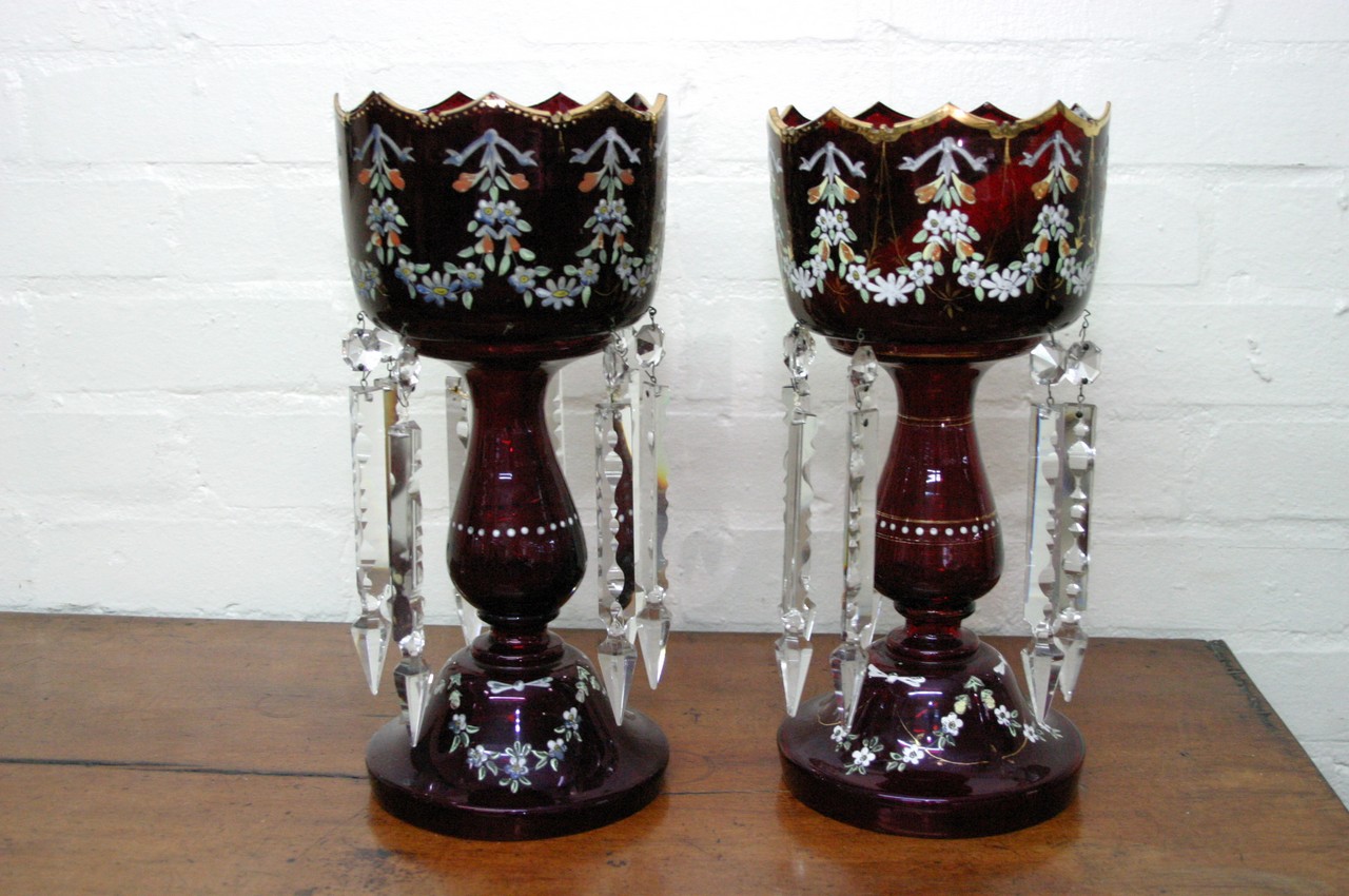 A pair of Victorian red glass lustres painted with