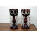 A pair of Victorian red glass lustres painted with