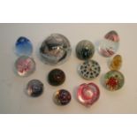 A collection of twelve paperweights including a vi