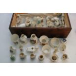 A box of crested ware items comprising many Goss e