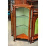 A small Mahogany corner cabinet fitted with two gl