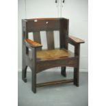 A pair of oak Liberty's open arm chairs with rush