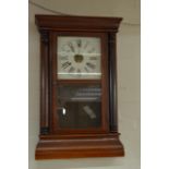 A mahogany 8 day wall clock.