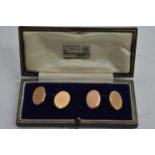 A pair of 15ct gold cuff links of oval shape in a