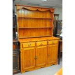 A pine dresser the raised back above three drawers