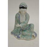 A Chinese figure of Kwan Yin seated in flowing gre